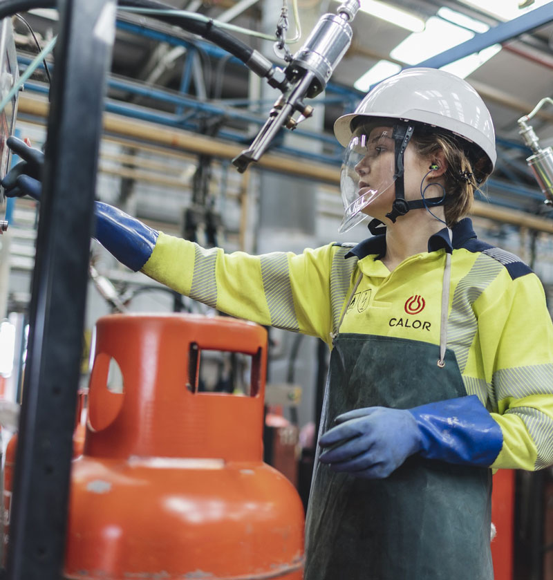 Calor plant operative wearing PPE filling and pressurising gas bottle